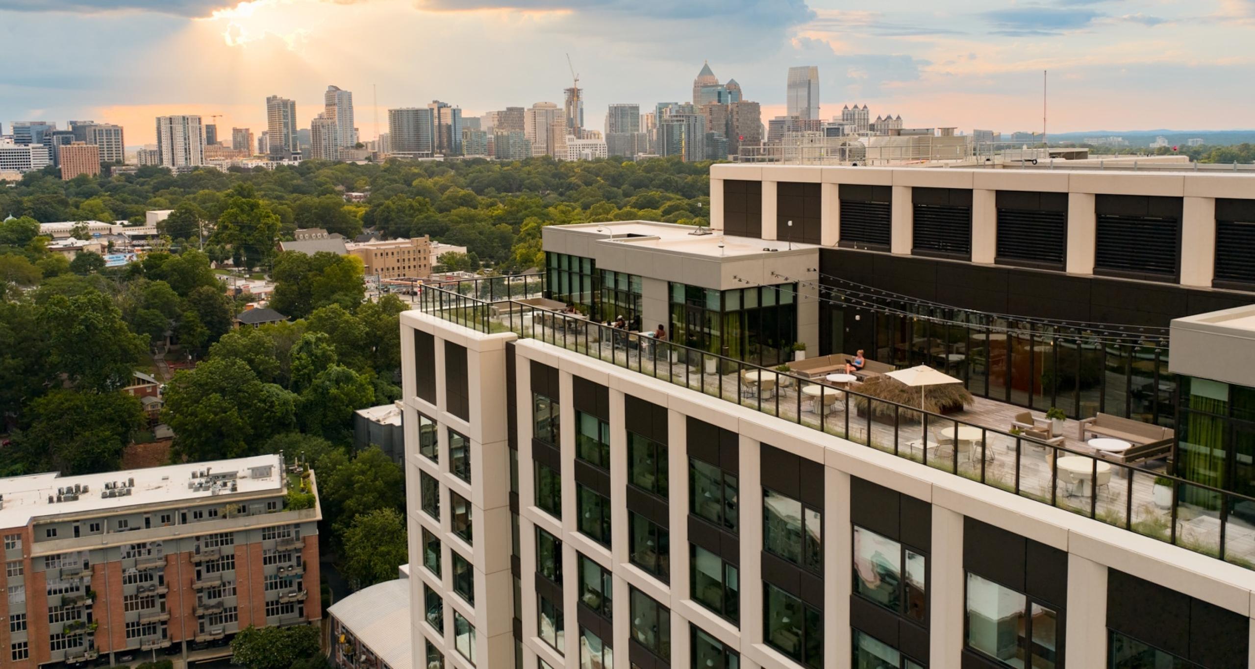 Aerial view of Scout Living's rooftop deck with Atlanta skyline in background