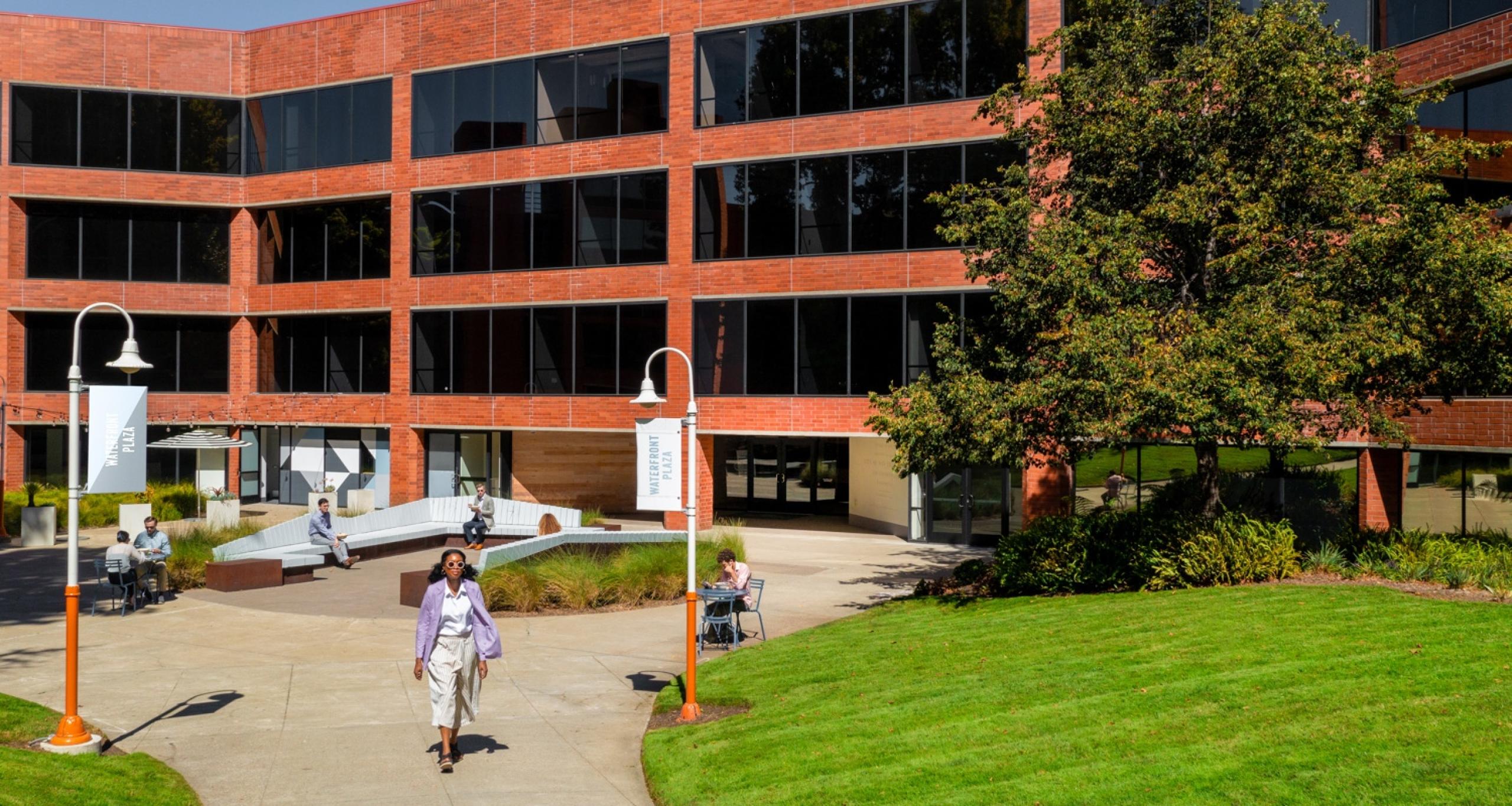 People sitting and walking in an outdoor courtyard at Waterfront Plaza