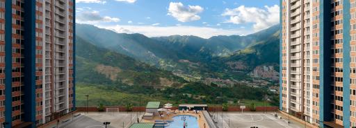 Rendering of apartment complex with sports courts in the middle and mountains in the distance.