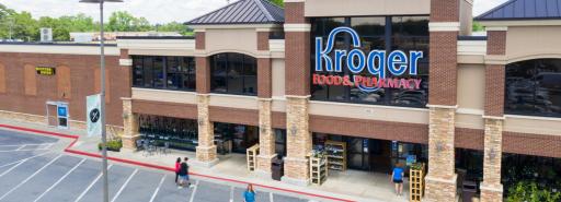 Low aerial view of the Kroger store exterior facade with pedestrians in driveway at Parkaire Landing