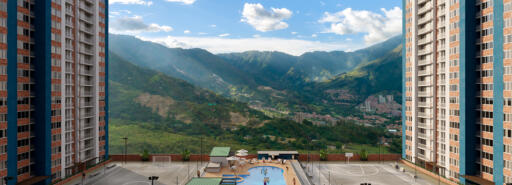Rendering of apartment complex with sports courts in the middle and mountains in the distance.